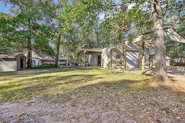 view of yard featuring an outbuilding and a garage