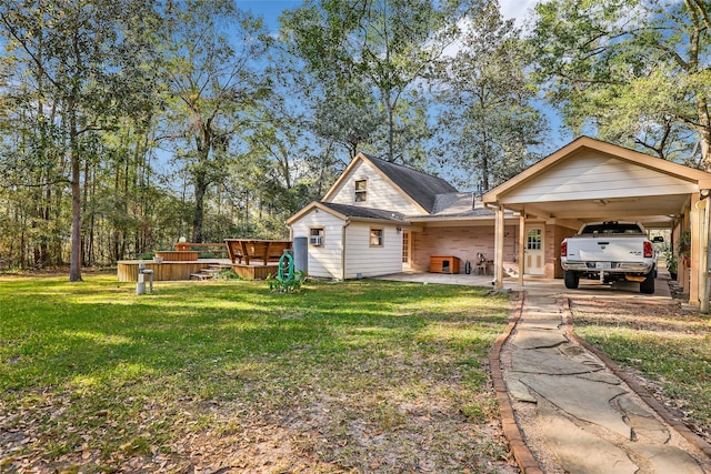 rear view of property featuring a yard and a carport