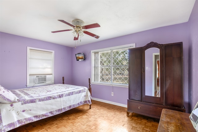 bedroom with ceiling fan, cooling unit, and light parquet floors