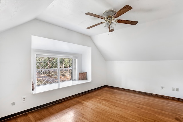 bonus room with lofted ceiling, hardwood / wood-style floors, and ceiling fan