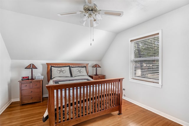 bedroom with light hardwood / wood-style floors, lofted ceiling, and ceiling fan