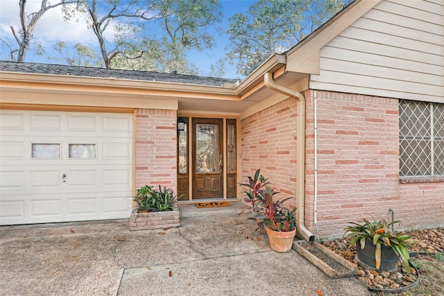 view of exterior entry with a garage