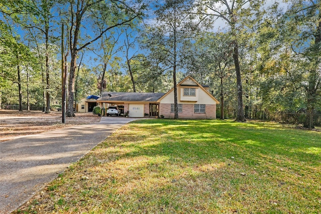 view of front of house with a front yard and a garage