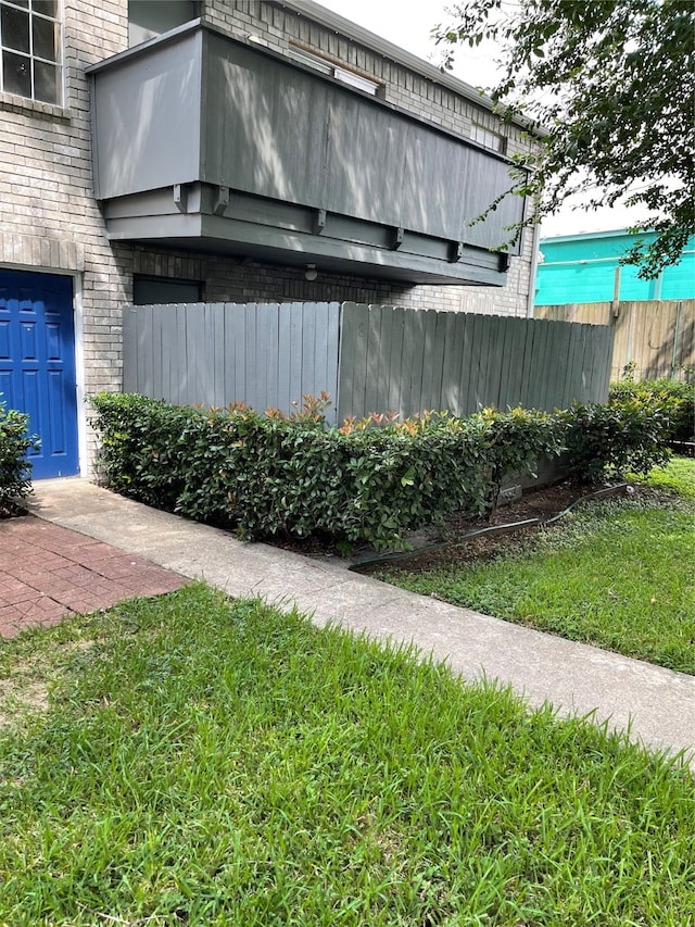 view of side of property with a lawn