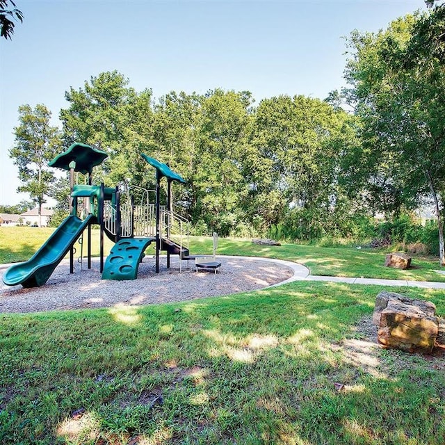 view of jungle gym featuring a lawn