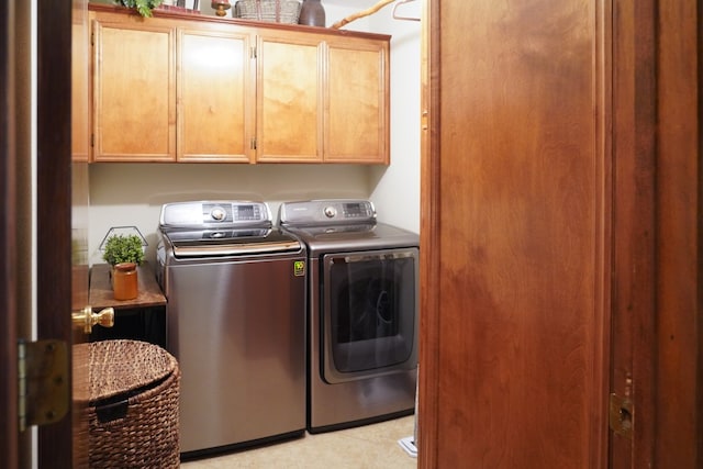 laundry area featuring cabinets and washer and clothes dryer