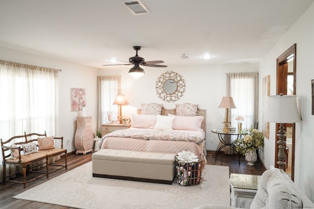 bedroom with ceiling fan and dark hardwood / wood-style flooring