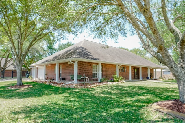 view of front of house with a front yard, a porch, and a garage