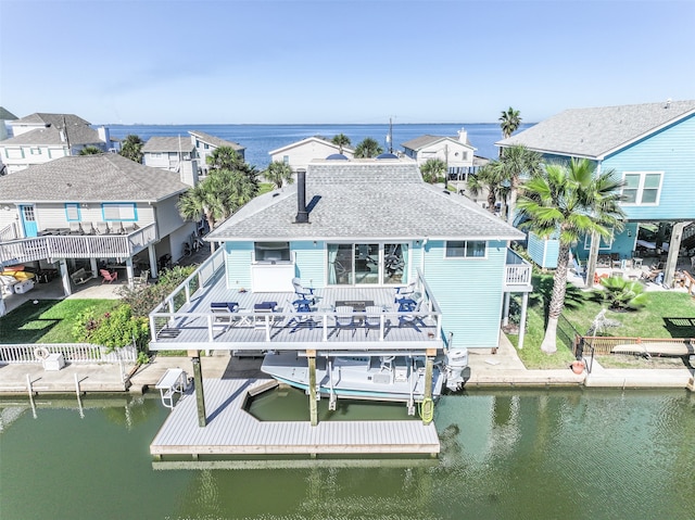 exterior space with a deck with water view and a balcony