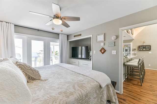 bedroom with hardwood / wood-style flooring, ceiling fan, and access to outside