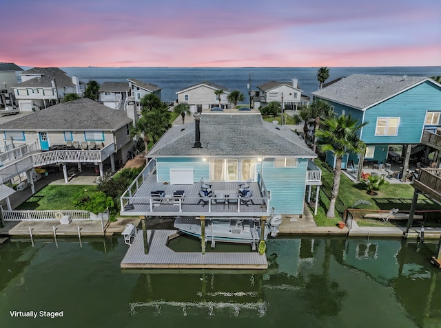 exterior space with a deck with water view