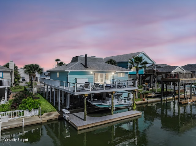 view of dock featuring a deck with water view