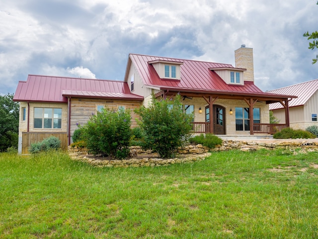 view of front of home with a front yard and covered porch