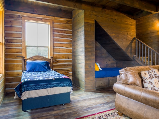 bedroom with beam ceiling, wooden walls, wooden ceiling, and dark hardwood / wood-style flooring