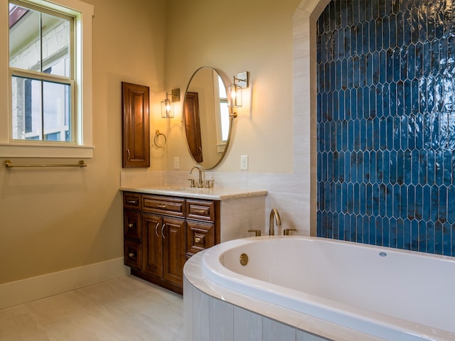 bathroom with vanity and a relaxing tiled tub