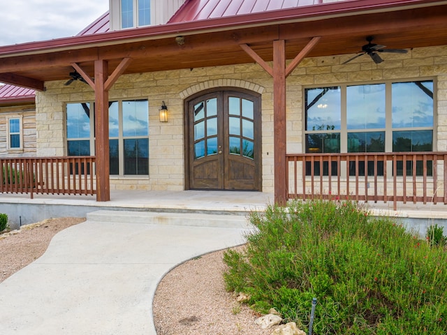 view of exterior entry with covered porch and ceiling fan