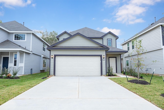 view of front of property with a front yard and a garage