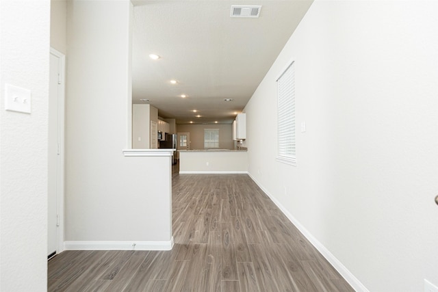 hallway with wood-type flooring