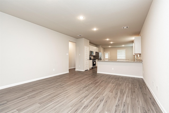 unfurnished living room with light hardwood / wood-style flooring