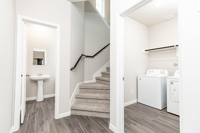 washroom featuring washer and dryer, light hardwood / wood-style floors, and sink