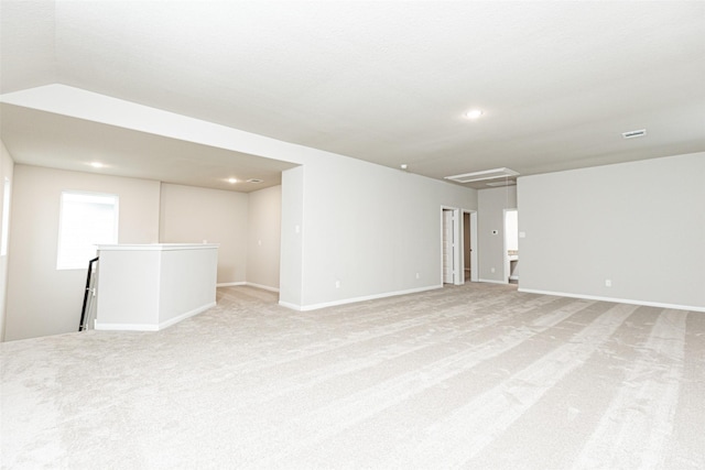 unfurnished room featuring light carpet