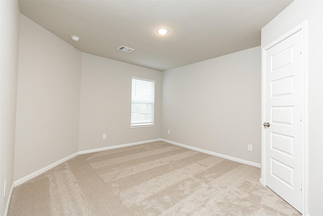 carpeted spare room with a textured ceiling