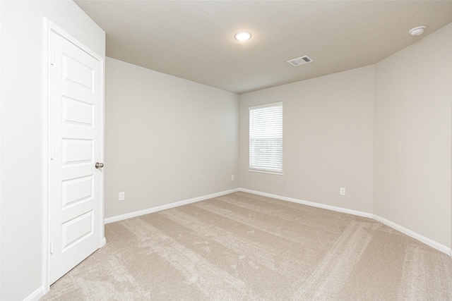 carpeted empty room with a textured ceiling