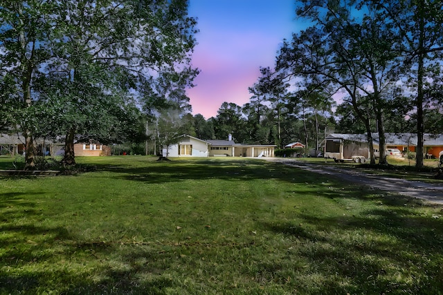 view of yard at dusk