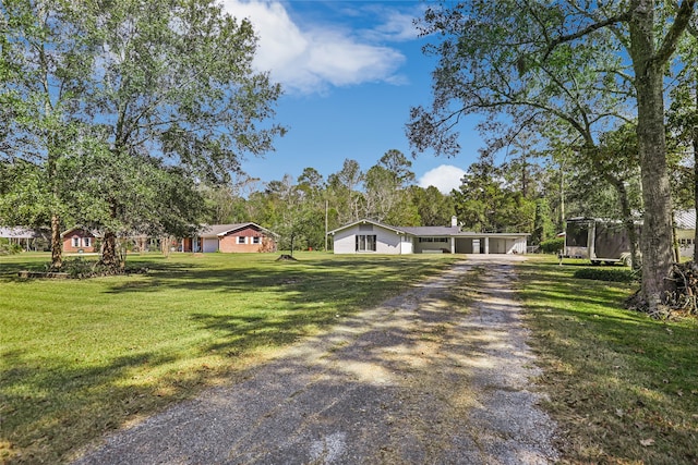 single story home with a front lawn and a trampoline