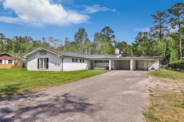 ranch-style home with a carport and a front yard