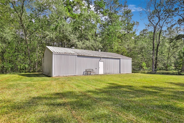 view of outbuilding featuring a yard