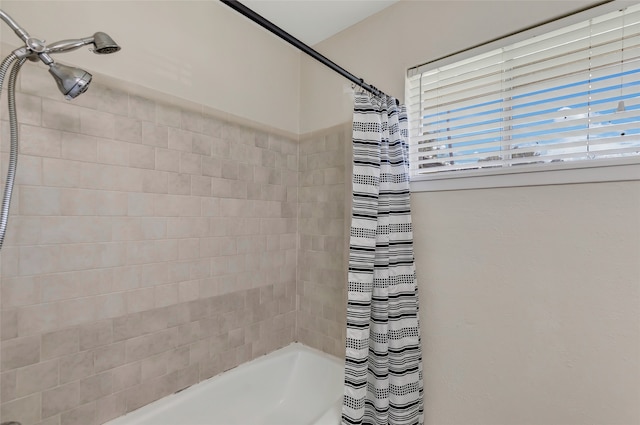 bathroom with shower / tub combo with curtain