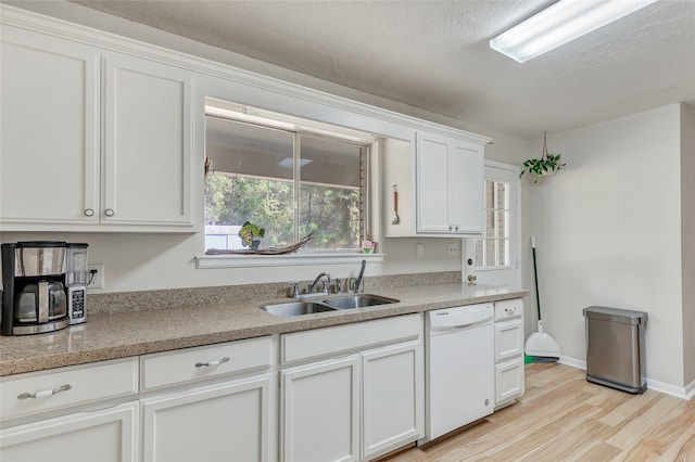 kitchen with white cabinets, a textured ceiling, white dishwasher, light hardwood / wood-style flooring, and sink