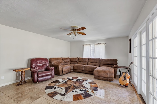 living room featuring light tile patterned floors and ceiling fan