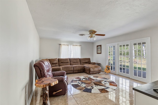 tiled living room featuring a textured ceiling and ceiling fan