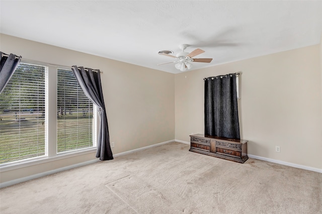 unfurnished living room featuring light colored carpet and ceiling fan