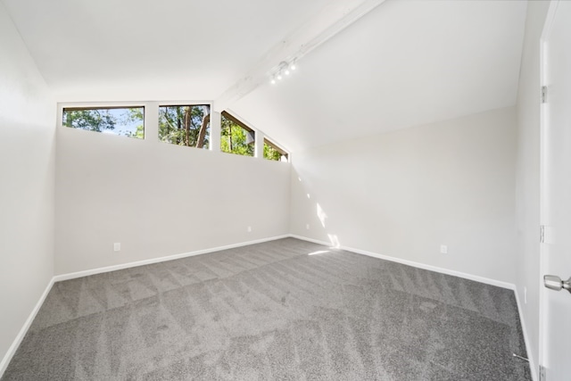 additional living space featuring vaulted ceiling with beams and carpet flooring