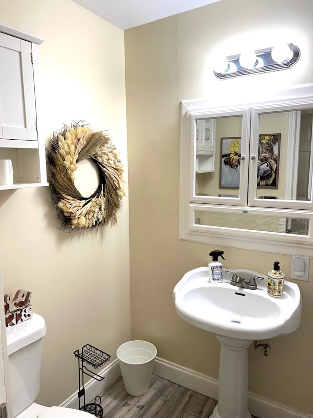 bathroom featuring toilet and hardwood / wood-style floors