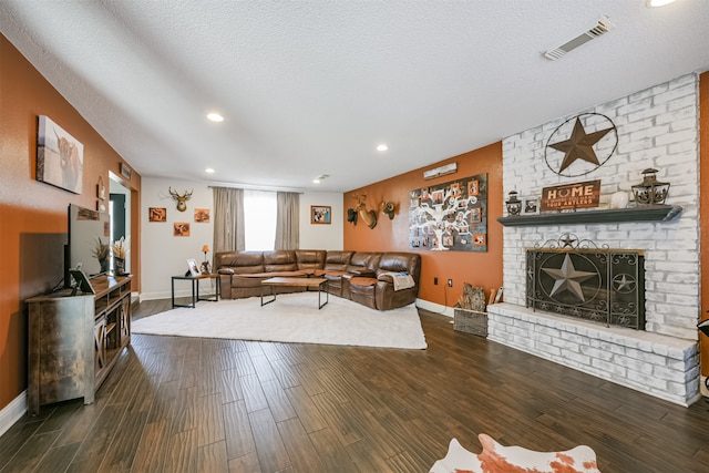 living room featuring a brick fireplace, a textured ceiling, and dark hardwood / wood-style flooring