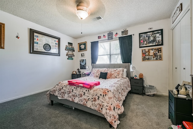 carpeted bedroom featuring a textured ceiling, a closet, and ceiling fan