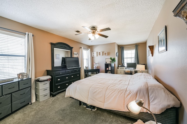 bedroom featuring a textured ceiling, carpet, and ceiling fan