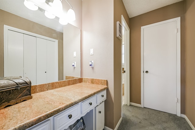 bathroom with vanity and a textured ceiling