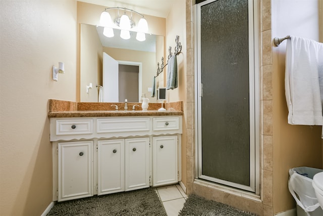 bathroom with vanity, walk in shower, and tile patterned floors