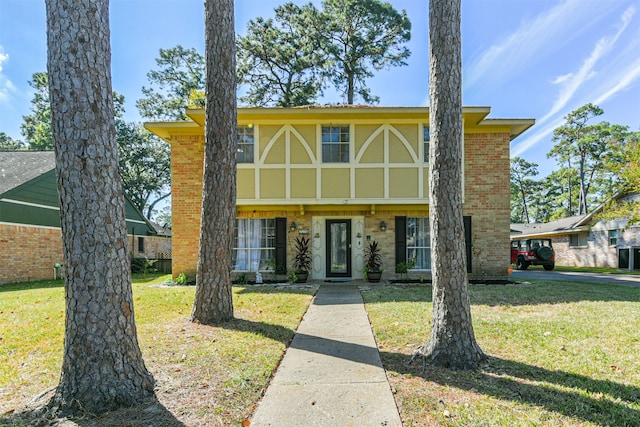 tudor house featuring a front lawn