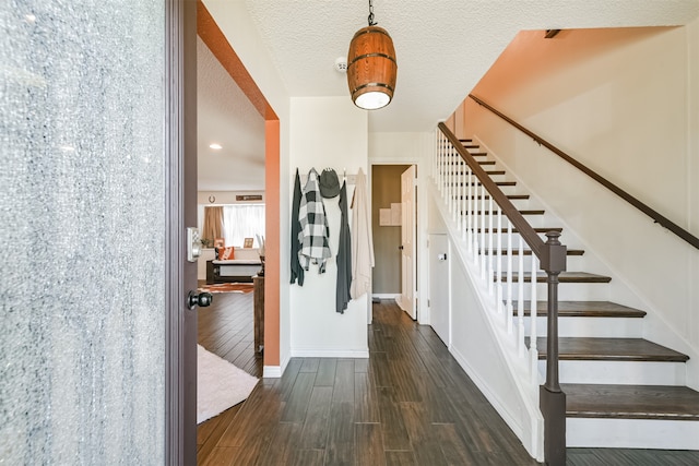 foyer with a textured ceiling and dark hardwood / wood-style flooring