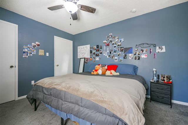 carpeted bedroom with a textured ceiling and ceiling fan