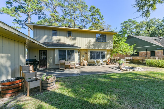 rear view of property with a patio area and a lawn