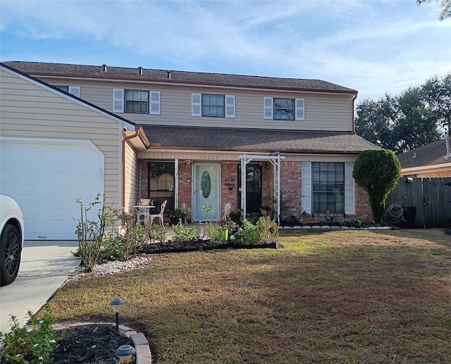 view of front property featuring a front yard and a garage