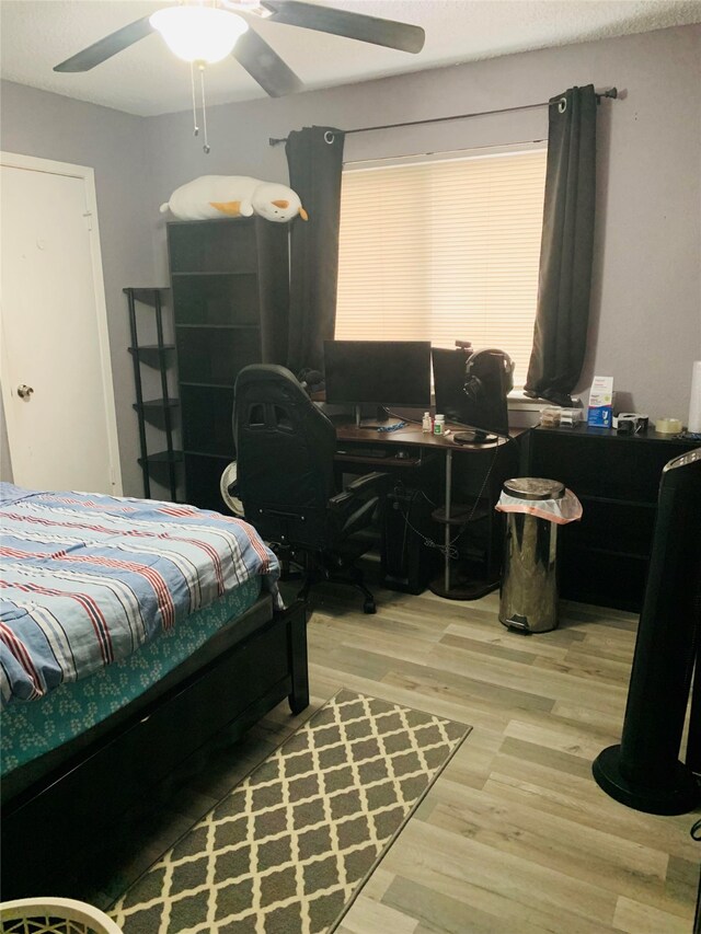 bedroom featuring wood-type flooring and ceiling fan