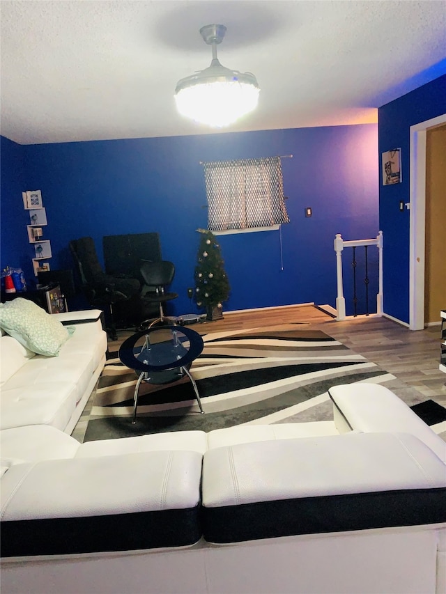 living room with hardwood / wood-style floors and a textured ceiling